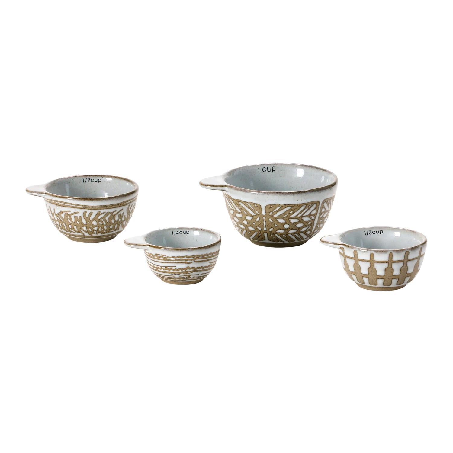 Stylish stoneware measuring cups featuring a wax relief design, available in a set of four sizes: 1 cup, 1/2 cup, 1/3 cup, and 1/4 cup.